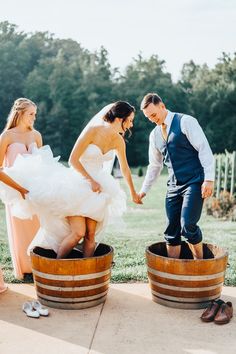 the bride and groom are getting ready to go into their wedding ceremony in wine barrels