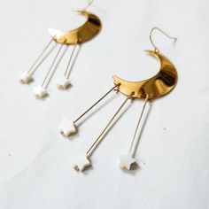 Made with 3 whimsical fresh water pearl stars dangling from a a gold crescent moon. Perfectly elegant for the celestial bride that would like to make a statement. These earrings are so fun for a party, elopement, rehearsal or perfect for the alternative bride on your wedding day. Every piece is handcrafted in my jewelry studio. Whimsical Gold Earrings With Moon Charm, Whimsical Gold Moon Jewelry, Whimsical Moon-shaped Gold Jewelry, White Moon Charm Jewelry For Party, White Moon Charm Party Jewelry, White Party Jewelry With Moon Charm, Celestial Bride, Gold Crescent Moon, Celestial Earrings