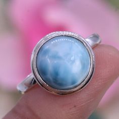 Free Shipping In The UK!! Next Day Dispatch!! The ring is solid 925 Sterling Silver Ring with the stone larimar with beautiful blue colour. The setting adds beauty and flair to the item. The ring is adjustable from UK size K to U. Metal - 925 Sterling Silver Metal Purity - 92.5% Solid Silver  Measurements: Stone Size: 6 mm Ring Weight: 3.7 grams About the Stone: Larimar is an earth-healing stone.  It connects with nature and will counteract imbalances in the earth's energy. Larimar helps to heal Hallmarked Larimar Jewelry, Blue Larimar Jewelry For Anniversary, Blue Larimar Opal Ring, Blue Larimar Round Rings, Blue Moonstone Ring Gift, Round Larimar Rings As A Gift, Turquoise Moonstone Ring In Sterling Silver, Blue Opal Ring In Sterling Silver, Spiritual Style, Blue Larimar Moonstone Ring