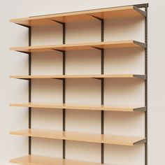 an empty book shelf with several shelves on each side and one in the middle, against a white wall