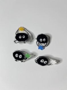 four black and white objects with eyes on them