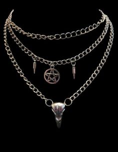 Looking for a bold and edgy accessory to complement your style? Look no further than my Layered Skull Necklace! This unique piece features a metal bird skull, complemented by faux bullets and a pentacle symbol, all suspended from layered chains.  The skull pendant is the focal point of this striking necklace, with intricate details that are sure to catch the eye. The faux bullets add an additional dimension of toughness and grittiness to this already rugged accessory. The pentacle symbol brings Edgy Halloween Streetwear Necklaces, Edgy Halloween Streetwear Necklace, Gothic Choker Jewelry For Streetwear, Gothic Choker For Streetwear, Alternative Style Festival Chain Jewelry, Punk Skull Necklace With Chain, Edgy Skull Chain Jewelry, Edgy Skull-shaped Chain Jewelry, Gothic Metal Skull Necklace