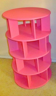 a pink shelf sitting on top of a carpeted floor