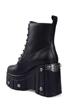 Bring bold biker edginess to your footwear collection with this heavy-duty combat boot set upon a lugged platform wedge studded with rivet-style screws and bolts. 4" heel; 3" platform 6" shaft Lace-up style Water resistant Leather upper and lining/rubber sole Imported Gothic Leather Combat Boots With Platform, Leather Punk Combat Boots With Chunky Platform, Punk Style Leather Combat Boots With Chunky Platform, Alternative Leather Platform Boots With Lug Sole, Leather Platform Combat Boots For Alternative Fashion, Edgy Leather Combat Boots With Chunky Platform, Edgy Leather Wedge Boots With Chunky Platform, Leather Chunky Platform Moto Boots For Alternative Fashion, Alternative Leather Moto Boots With Chunky Platform