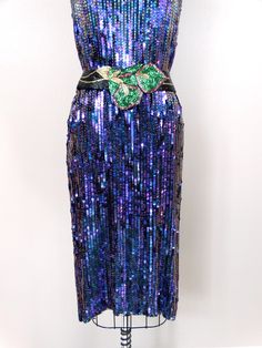 "This is a dazzling vintage dress. It's fully embellished with glass beading and sequins and in perfect condition! Measurements: Bust - 36\" Waist - 36\" Hips - 36\" Length - 41\" This dress comes from a pet-free and smoke-free home. If you would like more info or have any questions, please don't hesitate to ask!" Embellished Sequin Fabric For Evening Dress And Festive Occasions, Embellished Sequin Fabric For Festive Evening Dresses, Festive Embellished Sequin Fabric For Evening Dresses, Festive Sequin Cocktail Evening Dress, Festive Cocktail Dress With Sequins, Festive Cocktail Evening Dress With Sequins, Iridescent Sequin Dress For Night Out, Purple Embellished Sequin Fabric For Evening, Iridescent Sequin Dresses For Party Season