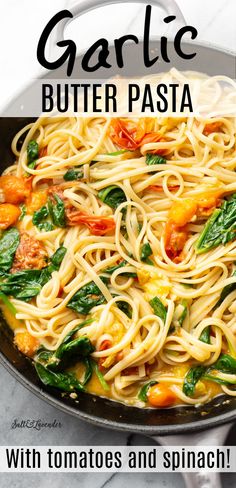 garlic butter pasta with tomatoes and spinach in a skillet