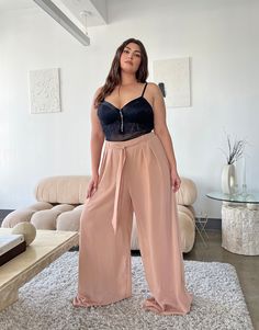 The Plus Size Wide Leg Chiffon Pants bring fun and funkiness to dress up any outfit—from work to brunch and beyond. Pair these trendy plus size trousers with a bodysuit and a blazer for a menswear-inspired street-style look. These pants are fully lined with smooth stretchy knit material and feature a non-removable tie belt, a wide leg silhouette, and elastic at the waist. The material is a non-stretchy chiffon. These pants are made from 100% polyester. Hand wash cold. Imported. Model is wearing Styling Wide Leg Trousers Plus Size, Flowly Pants Plus, Wide Leg Trousers Plus Size, Plus Size Wide Leg Pants Sweater, Bar Outfits Plus Size, Brown Wide Legged Jean Plus Size, Plus Size Brunch Outfit, Wide Leg Pants Outfit Plus Size, Plus Size Wide Leg Pants Outfit