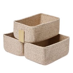 two woven storage baskets, one with a gold tag on the top and one with a brown label on the bottom