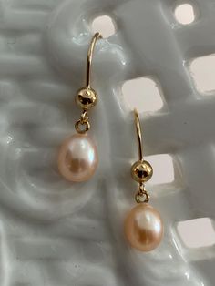 Stunning High-Luster beautiful plump pearls. Freshwater Akoya Teardrop Pearl Earrings, adorned with gorgeous nacre. These high-quality pearls, produced in the 1950s, are sure to captivate your attention.  Grown in freshwater estuaries in Australia, these pearls are cultivated in the same oysters (Pinctada Fukata) as their saltwater Akoya counterparts. The result is a breathtaking iridescent nacre that adds an extra touch of elegance to these pearls. Abandoned in a warehouse for over fifty years, these pearls have now emerged back into the world, ready to be admired and cherished. Each pearl possesses its own unique beauty, making them truly one-of-a-kind treasures. I sort, select, and match each pair at my bench in Palm Springs.  All my earring mounts are made in the US by a certified meta Dainty Yellow Gold Teardrop Pearl Earrings, Pink Teardrop Pearl Earrings For Formal Occasions, High Luster Drop Pearl Earrings For Gift, Gold Briolette Pearl Earrings With High Luster, Gold Hypoallergenic Pearl Earrings For Gifts, Gold Hypoallergenic Pearl Earrings For Formal Occasions, Pear-shaped High Luster Pearl Earrings Gift, Pear-shaped High Luster Pearl Earrings, Briolette High Luster Pearl Earrings As Gift