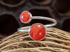 Dainty handcrafted and highly polished 925 sterling silver ring with red synthetic resin mixed with ground howlite in coral optics Ring size is adjustable due to the open design Thickness ring band 1 mm Total width is about 10 to 15 mm at the front, depending on how you bend the women's ring. The larger gemstone has a diameter of 8 mm, the smaller one 6 mm. Cleaning & care Silver jewelery reacts with sweat, body cosmetics and cleaning agents by tarnishing. We therefore recommend that you refrain Adjustable Open Ring In Red, Adjustable Open Red Ring, Ring With Red Stone, Body Cosmetics, Open Design, Red Stone, Ring Band, Rings Statement, 925 Sterling Silver Ring