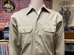 "Vintage New Old Stock Old Kentucky khaki long sleeve work shirt size 14S, fits like a size Small. Chest pockets. excellent condition, never wear, 65% polyester 35% cotton, made in U.S.A. Please, check carefully the measurements, photos and description of the article before buying it, we do not accept changes or returns. Measurements lying face down from outside: 19 1/2\" Across chest underarm to underarm. 16\" Shoulder to shoulder across the front. 24 1/2\" Sleeve length from shoulder to cuff. Long Sleeve Work Shirt, Camo Shorts, Collar Neck, Face Down, Work Shirt, Small Chest, Pocket Pants, Work Shirts, Kentucky