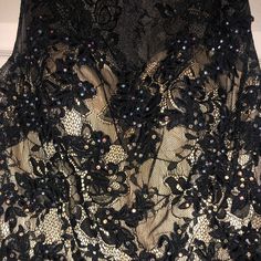 Never Worn Cocktail Dress With Beautiful Stones. Overlay Is Black Lace With A Gold Layer Beneath. Purchased For A Pageant But Ended Up Choosing To Wear Something Different. Size 6, Fits Like A Size Small!!! Glamorous Black Lace Evening Dress, Black Lace Dress For Party Season, Black Lace Mini Dress For Prom, Black Embellished Dress For Prom, Black Embellished Sleeveless Dress, Glamorous Black Lace Mini Dress, Glamorous Black Lace Dress, Black Embellished Lace Dress, Black Lace Embellished Dress