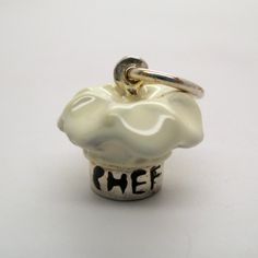 "This three-dimensional, sterling silver Chef Hat charm is beautifully hand-enameled in white. The silver band on the hat is inscribed with the word Chef. Made by Brown County Silver. Vintage but in brand new, never worn condition. Diameter 1/2\" diameter Weight 3.5 grams See more @ https://www.etsy.com/shop/brocosi" Gift For Chef, Brown County, Chef Hat, Baking Gifts, Chef Gifts, Food Jewelry, Chefs Hat, Gifts For Cooks, Wife Gift