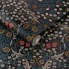 a close up view of a black and blue wallpaper with white flowers on it