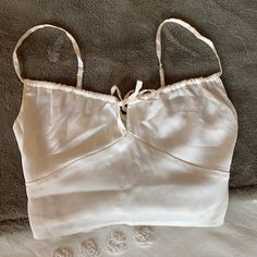 Hollister Silk Cami In A Size Xs! Brand New, Never Worn Before! I Love This Cami But It’s A Little Too Small For Me Up Top And I Already Took The Tags Off. Has A Tie In The Front And Straps Are Adjustable! I Also Included The Original Product Picture So You Can See How It Looks Tied! Feminine White Top With Built-in Bra, White Summer Tops With Built-in Bra, Feminine White Camisole Crop Top, Trendy White Camisole For Day Out, White Casual Party Camisole, Casual White Party Camisole, White Feminine Crop Top With Spaghetti Straps, White Camisole Crop Top For Day Out, White Crop Top Camisole For Summer