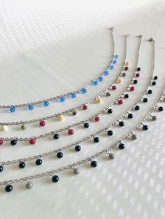 Here is the "Hanging Pearls" choker necklace collection. 🔥 Each bead is handcrafted by me. I work on glass bars in a very hot flame to shape the glass to suit your needs. It's called glass spinning Received idea : Glass beads are fragile: No! The spherical and small beads are very strong and bounce like marbles Practical information : 💧All metal elements are made of stainless steel. Thus, these jewels are not afraid of water and provide comfort and impeccable quality. 📏 The necklaces are adju Silver Dangling Beads For Gifts, Silver Dangling Beads As A Gift, Metal Necklaces With Polished Beads As A Gift, Silver Czech Glass Dangle Necklaces, Adjustable Dangle Glass Necklace, Glass Jewelry With Dangling Beads For Party, Polished Beads Choker Necklace For Gifts, Party Jewelry With Dangling Glass Beads, Gift Metal Necklaces With Polished Beads