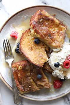 french toast with berries and ice cream on a plate