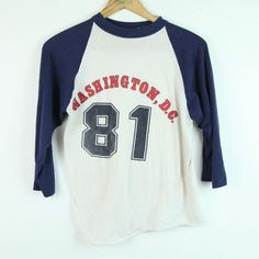 "Vintage Washington D.C. raglan shirt from 1981. It has fading to graphic and pilling throughout, see photos. It is a 5050 polycotton blend.  It is a size M but please check the measurements it seems closer to an XS/S. Please see all photos for condition. Collar to Sleeve Cuff 20\" Chest 37\" Length 22\" B120" Raglan Shirts, Washington Dc, Washington, Womens Clothing Tops, T Shirts For Women, Tops & Tees, T-shirt, ? Logo, Clothes For Women