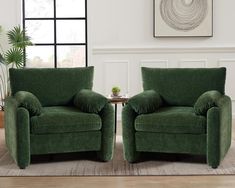 two green chairs sitting next to each other in a living room