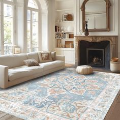 a living room filled with furniture and a fire place in front of a large window