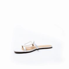 The Melissa sandal is defined by an oversized cutout metal ornament adding glamour to this leather slip on. Made from ultra-soft leather with a molded foam insole, the flat is effortlessly comfortable, and looks just as amazing with pants as it does with dresses. Color: White Leather Upper/Leather Lining/Manmade sole Flat slip on sandal cutout ornament detail 4 mm padded footbed Formal Summer Slip-ons With Flat Heel, Formal Slip-ons With Flat Heel For Summer, Formal Summer Slip-ons, Elegant Slip-on Synthetic Slippers, Formal Summer Flat Slip-ons, Formal Flat Slip-ons For Summer, Elegant Flat Slides For Formal Occasions, Elegant Formal Flat Slides, Elegant Formal Summer Slip-ons