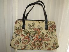 "1960s' lovely large double black vinyl strap tote/wrist handbag by Verdi U.S.A. Purse has side black vinyl leather and bottom, with double side inside slot pockets, two pockets inside the snap closure. So you have a lot of inside pockets to hide things. The tapestry print is beige background with flowers in colors of greens, rose, black, and beige. Handbag has 4 gold bottom tips. Length from Bottom 16\", Length from Top 12\", Bottom Width about 4\", Height 9\", Straps about 10\". Handbag is in Vintage Tote Satchel For Shopping, Vintage Satchel Tote For Shopping, Retro Satchel With Leather Handles For Shopping, Vintage Shoulder Bag With Rolled Handles For Daily Use, Vintage Satchel With Rolled Handles, Vintage Satchel Shoulder Bag With Rolled Handles, Vintage Satchel With Rolled Handles For Daily Use, Vintage Travel Satchel With Rolled Handles, Beige Handbag