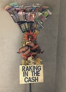 a sign that says raking in the cash on top of a stand with flowers