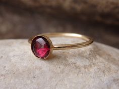 Garnet Gold Ring, Red Gemstone Stacking Ring, Dark Red Minimalist Ring, January Birthstone, Gold Filled Ring, Garnet jewelry, Red Stone Ring This red garnet gold stacking ring will be a perfect gift for women. It is made of 14k gold filled and garnet stone. Measurements: Size- all The center stone is 6 mm The ring will be packed in a gift box. FOR MY RINGS COLLECTION HERE: https://www.etsy.com/il-en/shop/rebekajewelry?section_id=14282915&ref=shopsection_leftnav_9 TO GET TO MY SHOP: https://w Dainty Red Round Jewelry, Red Round Stone Promise Ring, Red Garnet Round Band Jewelry, Red Round Solitaire Jewelry, Red Ruby Birthstone Ring With Round Stone, Red Solitaire Birthstone Ring, Red Solitaire Birthstone Ring With Round Band, Red Solitaire Ring With Round Band, Oval Ruby Gemstone Stackable Rings