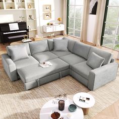 a living room with a large sectional couch and coffee table in it's center