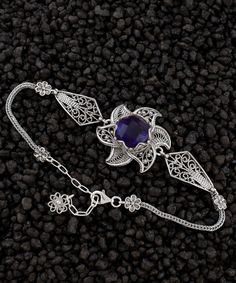 Amethyst Silver Filigree Lotus Flower Bracelet, 925 Sterling Silver Handmade Artisan Crafted Purple Floral Ornate Women Chain Bracelet February bracelet, birthstone bracelet, silver gift for her Gemstone: Amethyst 12mm. Material: 925 Sterling Silver ( NICKEL FREE ) Bracelet Length: 18 cm + 5 cm // 7 Inches + 2 Inches Extender Bracelets Width: 2.5 cm // 1 Inches Adorn your wrist with the ethereal elegance of the Amethyst Silver Filigree Lotus Flower Bracelet. Meticulously handcrafted from the finest 925 sterling silver, this bracelet is a testament to artisanal mastery and timeless craftsmanship. Its delicate chain, a seamless fusion of art and intricacy, drapes like a whisper of beauty around your wrist. At its heart blooms a resplendent lotus, meticulously fashioned with intricate filigre Traditional Purple Jewelry For Formal Occasions, Formal Silver Amethyst Bracelet, Sterling Silver Purple Jewelry With Intricate Design, Purple Sterling Silver Jewelry With Intricate Design, Sterling Silver Jewelry With Intricate Design In Purple, Traditional Purple Gemstone Jewelry, Sterling Silver Purple Bracelet As Gift, Purple Sterling Silver Bracelet As Gift, Silver Gemstone Chain Bracelet Gift