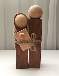 two wooden pegs tied with twine on top of each other