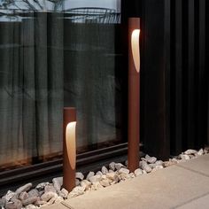 some lights that are sitting on the side of a window sill in front of a building