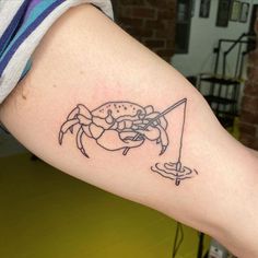 a person with a crab tattoo on their arm