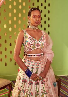 Editor's Note Blush Ivory Floral Embroidery Sleeveless Blouse & Floral Hand Embroidery Sb Signature Enchanted Lehenga With Powder Pink Silk Organza Patch Work Dupatta. Fabric: Dupion, Organza Color: Ivory Care: Dry Clean Only Disclaimer: Product Color May Slightly Vary Due To Photographic Lighting Sources Or Your Monitor Setting. About the Designer Siddhartha Bansal, label epitomise its design philosophy touring around " Golden bird" nation to present day India, in the wanderlust for rich Craft Sleeveless Lehenga With Floral Embroidery For Eid, Fitted Sleeveless Sets With Multicolor Embroidery, White Chanderi Choli With Floral Embroidery, Multicolor Sleeveless Sets With Intricate Embroidery, Sleeveless Multicolor Sets With Intricate Embroidery, White Sleeveless Traditional Wear With Resham Embroidery, Sleeveless Sharara With Floral Embroidery For Festivals, Transitional Bollywood Choli With Floral Embroidery, White Sleeveless Traditional Wear For Festivals