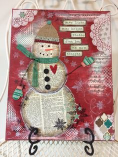 a snowman made out of an old book with words written on the front and bottom