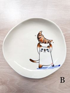 a white plate with a cat on it