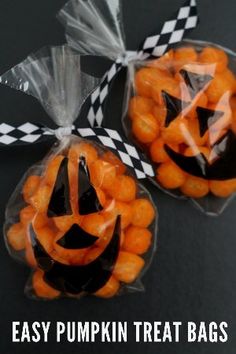 two bags filled with candies and jack - o'- lantern faces on top of each other