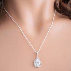 "* Diamond shaped rhodium plated cubic zirconia post earring, with a 925 sterling silver post and a LUX cubic zirconia teardrop pendant surrounded by cubic zirconia crystals. This pair of earrings are absolutely stunning and measure 1 1/4\". Matching cubic zirconia pendant with a sterling silver chain in 16\", 18\", or 20\" lengths. * The camera does not capture the beauty and sparkle of the earrings and necklace set * TAKE 10% OFF $75 OR MORE WITH COUPON CODE ~ WEDDINGS10 * TAKE 15% OFF $100 OR Brilliant Cut Teardrop Bridal Earrings For Wedding, Brilliant Cut Teardrop Bridal Earrings, Teardrop Brilliant Cut Bridal Earrings, Silver Diamond Cut Bridal Earrings For Wedding, Silver Bridal Necklace With Prong Set Cubic Zirconia, Gift Bridal Earrings With Halo Setting In Silver, Silver Bridal Earrings With Halo Setting Gift, Crystal Wedding Earrings With Halo Setting, Sterling Silver Bridal Earrings With Diamond Cut For Wedding