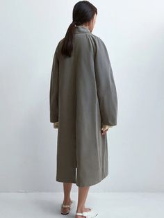 The Cordera Wax Cotton Trench in Taupe Grey is a unique and special rainy trench coat that is light and water repellent. Designed with a relaxed fit and long length, it's a perfect piece for the in-between season. Detailed with covered buttons and two ornamental pockets. 50% cotton / 39% polyester / 16% polyamide Hand wash or dry clean Made in Spain — Cordera, founded by sisters Mónica and María in 2008, has cultivated a distinct identity rooted in minimalism and ethical production practices. Ne Spring Long-sleeved Raincoat With Button Closure, Spring Long Sleeve Raincoat With Button Closure, Solid Raincoat For Work In Spring, Oversized Solid Raincoat With Pockets, Spring Raincoat With Button Closure, Oversized Raincoat With Pockets, Oversized Solid Color Raincoat For Fall, Oversized Solid Raincoat For Fall, Oversized Solid Raincoat For Spring