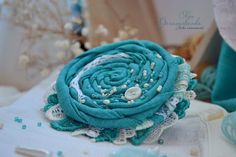 a blue flower sitting on top of a table next to some buttons and other items