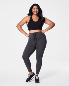 Our cozy, peachy-soft high-rise leggings feature a built-in waistband that gently smooths your curves with light core compression—plus an adjustable tunnel drawstring for the perfect fit. Made with super-soft fabric with 4-way stretch in a heathered, tonal design, these leggings are enhanced with strategically placed and engineered back-v-seaming that defines the booty. The result? A look that suits low-impact movement and just-as-easygoing outings.​ | Spanx Women's SPANXsmooth SoftStretch High-Rise Leggings Sporty 4-way Stretch Tights For Loungewear, Sporty Loungewear Tights With 4-way Stretch, Sporty Tights For Loungewear With 4-way Stretch, Functional 4-way Stretch Leggings For Loungewear, High Rise Leggings, Soft Fabric, Soft Fabrics, Perfect Fit, Built In