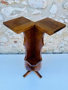 an unusual wooden table with two open sides