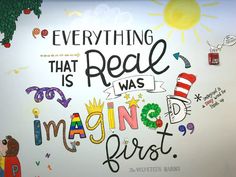 there is a mural on the wall that says everything that real is magic and bright