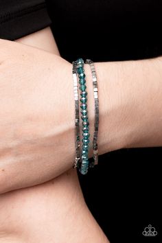 Two rows of dainty silver cube beads and one row of iridescent blue crystal-like beads are threaded along stretchy bands around the wrist, creating stellar layers.

Sold as one set of three bracelets. 1st Dibs, Stay Blessed, Silver Strand, Rose Gold Beads, Oil Spill, Cube Beads, Iridescent Blue, Crystal Beads Bracelet, Paparazzi Accessories