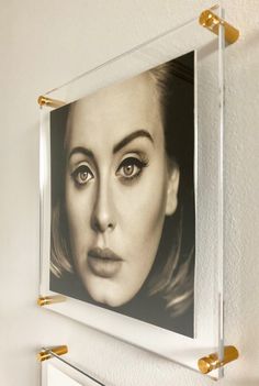 a black and white photo of a woman's face is hanging on the wall