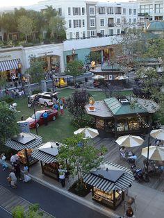 an aerial view of people sitting at tables and eating in the open air on a sunny day