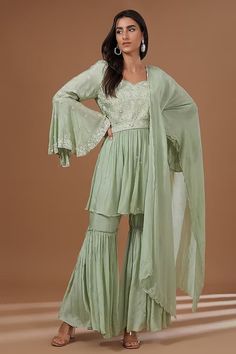 Mint green peplum padded kurta with pearl, cutdana, sequin, thread embroidery in floral pattern. Paired with pleated sharara and dupatta. - Aza Fashions Green Long Sleeve Sharara For Wedding, Festive Green Peplum Sharara, Traditional Green Sharara With Peplum, Green Peplum Festive Dress, Fitted Light Green Festive Sets, Festive Green Peplum Dress, Festive Light Green Fitted Sets, Green Georgette Set With Ruffles, Green Ruffled Traditional Sharara