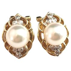 A gorgeous pair of vintage c1960s Cultured pearl and diamond earrings. Crafted in rich 9ct yellow gold the earrings are a clip on style with gold ear clips, the centre set with a creamy and lustrous cultured pearl. Surrounding the pearl there are six single cut bright white diamonds bezel set in 9ct white gold, above and below the pearl in a trefoil setting. A truly beautiful pair of vintage earrings. Stamped to the reverse 9k, c1960s. Condition: Very good used condition overall, some signs of u Ear Clips, Pearl And Diamond Earrings, Vintage Clip, Pearl Diamond, Bezel Diamond, Clip Earrings, White Diamonds, Cultured Pearls, Bezel Setting