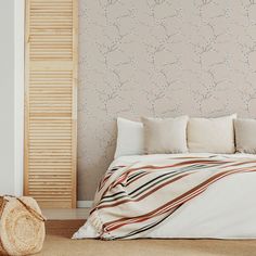 a bed sitting next to a wall with a wooden slatted headboard