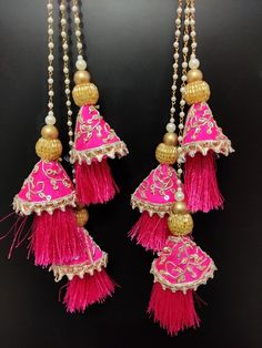 15" wedding fuchsia pink indian bridal lehenga embellishment zardosi decorative hanging tassel | silk fabric wedding tassel with bead chainHandmade Hanging/tasselsMaterial:Silk, Thread, MotifsPackage Contents: 2Key Features:Embroidery art workThis  is good match with both Indian and western outfits and are superb for wedding and festive parties.This would be best complement to your designer saree, lenhga or any other kind of dress.This is the combination of traditional and modern embroidery work Pink Traditional Wear With Dori Work, Pink Kundan Embroidered Fabric For Wedding, Diwali Pink Silk Thread Embroidered Fabric, Pink Silk Thread Embroidered Fabric For Diwali, Traditional Pink Silk Thread Choli, Pink Silk Dupatta With Dori Work, Pink Silk Choli With Dori Work, Pink Silk Thread Lehenga For Navratri, Pink Silk Thread Dupatta For Reception